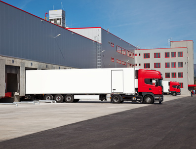 cargo trucks at an entrance of a warehouse